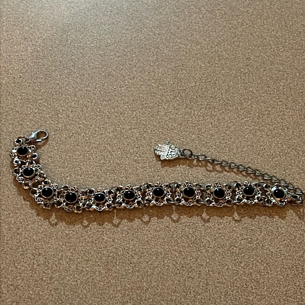 Silvertone bracelet with black beads and a hanging charm